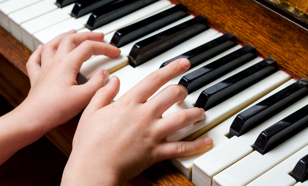 Child hands palying piano at Mr Piano Lessons Calgary